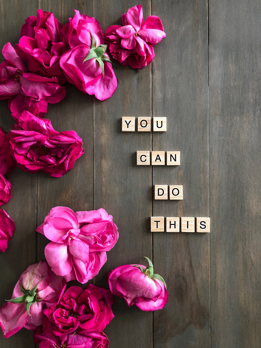 You Can Do This phrase on wooden background with pink roses